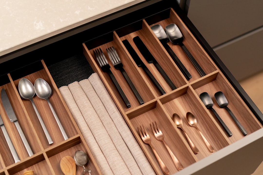 A kitchen drawer with an assortment of everyday utensils and spoons